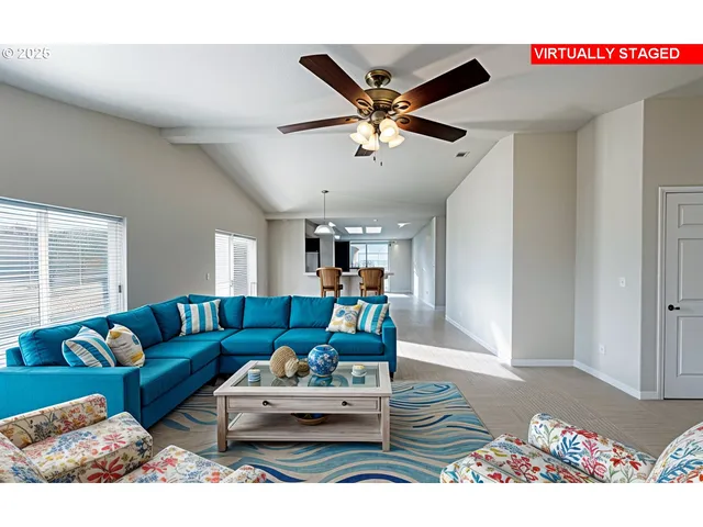 a living room with furniture and a ceiling fan