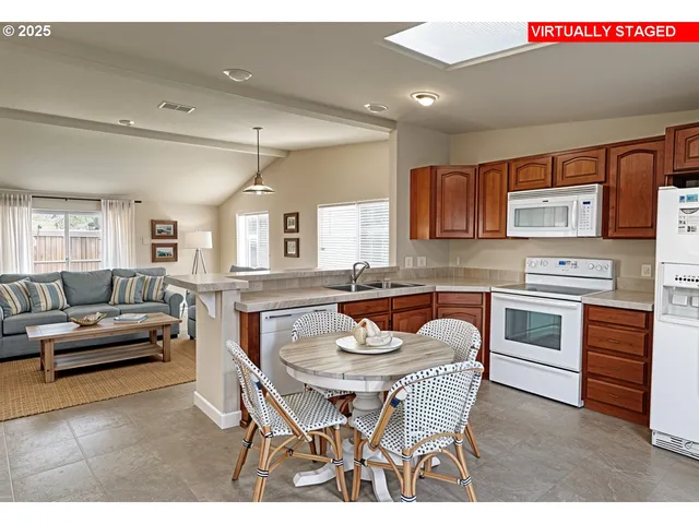 a kitchen with stainless steel appliances granite countertop a sink dishwasher and cabinets with wooden floor