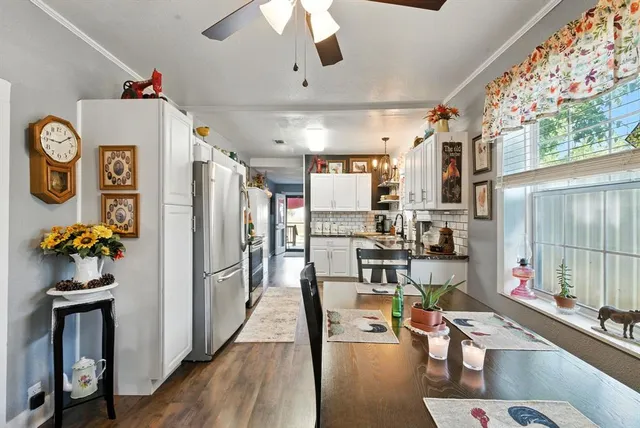 a room with stainless steel appliances kitchen island granite countertop a refrigerator and microwave