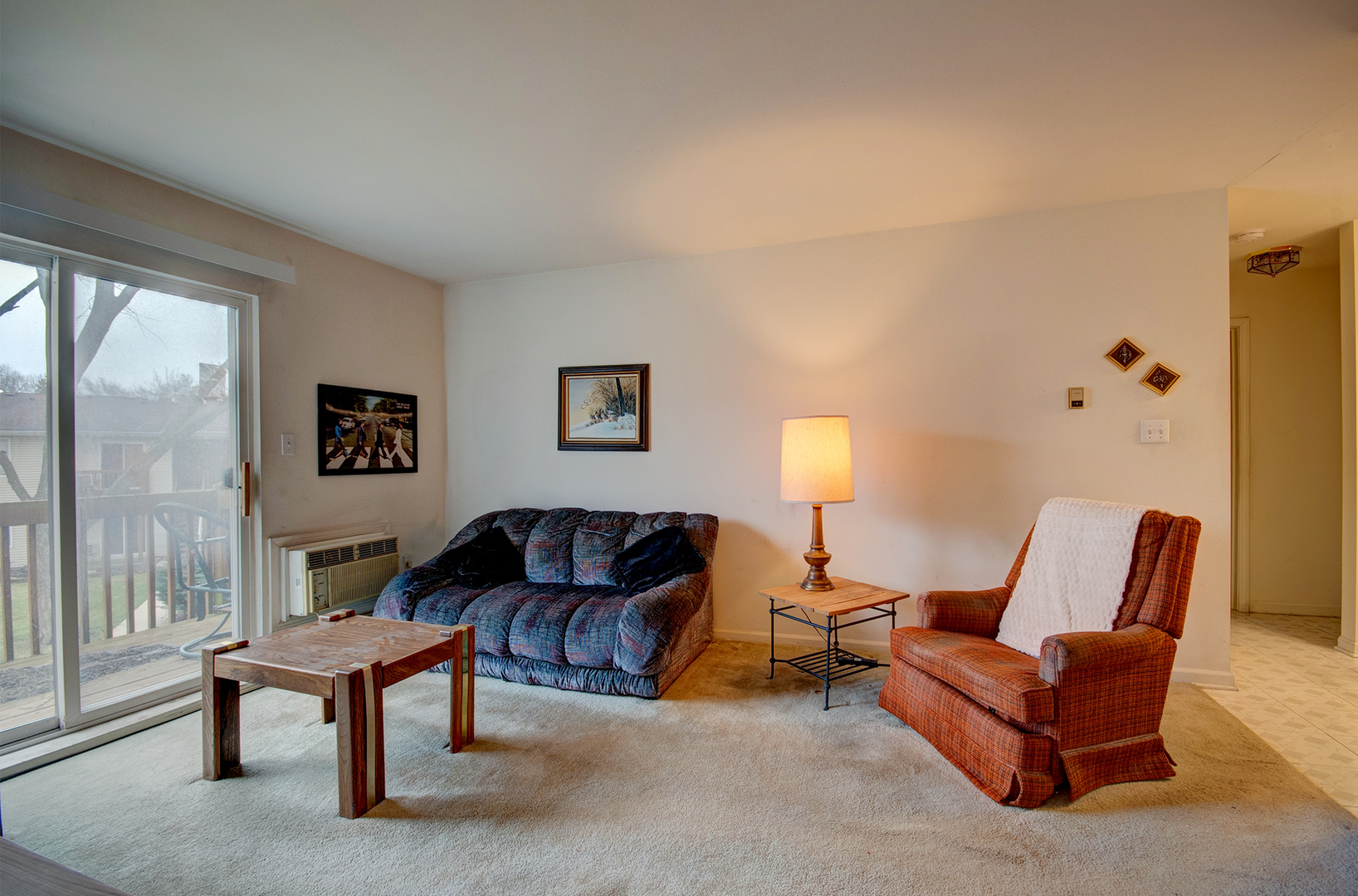 2100 Light Road, Unit 211 Oswego, IL 60543 - Photo 3 of 17 a living room with furniture a window and a lamp