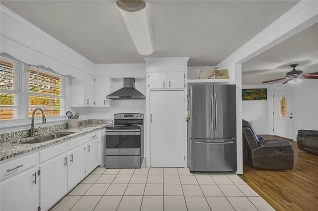 a kitchen with a refrigerator sink and cabinets