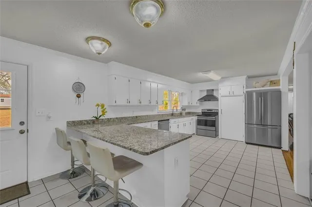 a kitchen with a table and chairs