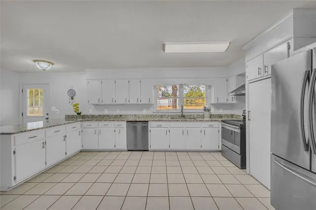 a kitchen with sink cabinets and window
