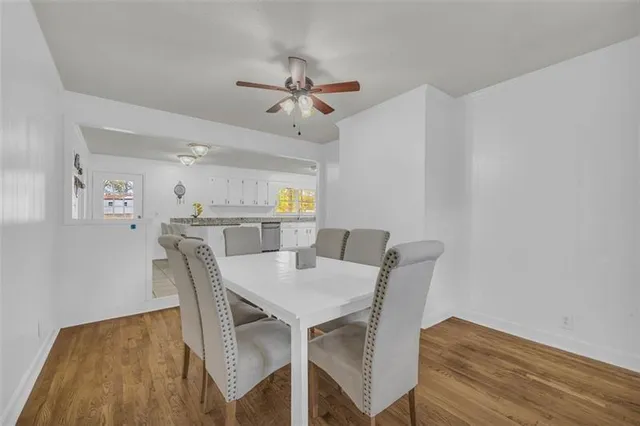 a view of a dining room with furniture and wooden floor