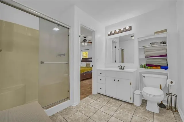 a spacious bathroom with a toilet sink and a mirror