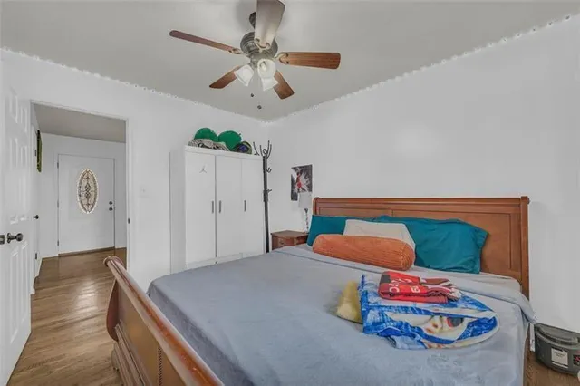 a bedroom with a bed and a chandelier