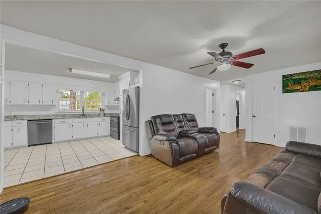 a living room with furniture and kitchen view