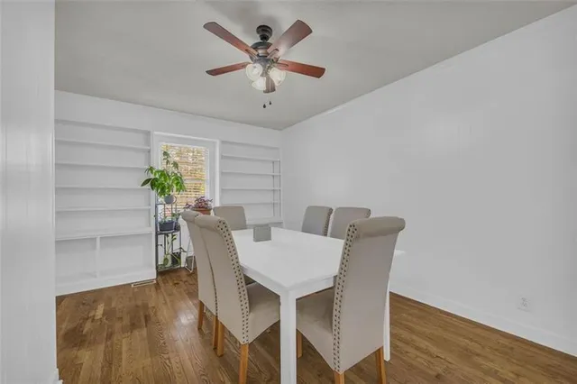 a view of a dining room with furniture and a potted plant