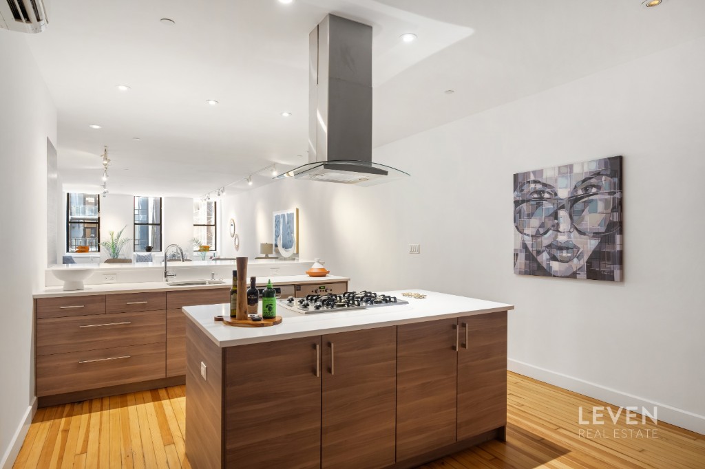 19 Murray Street, Unit LOFT 4 Manhattan, NY 10007 - Photo 6 of 13 a bathroom with a sink a mirror and a toilet