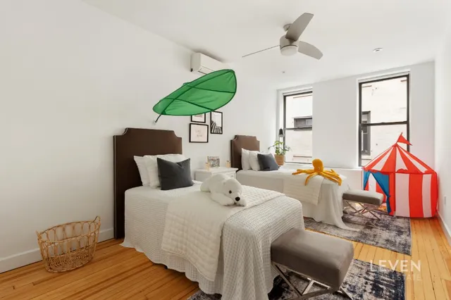 a bathroom with a bathtub shower sink vanity and toilet