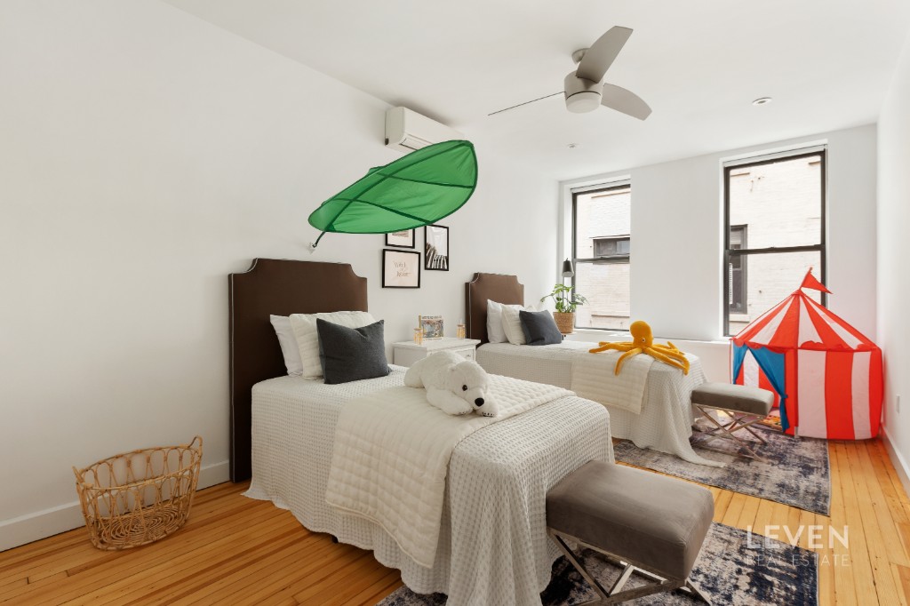 19 Murray Street, Unit LOFT 4 Manhattan, NY 10007 - Photo 9 of 13 a bedroom with a bed and a chandelier