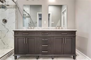 6814 Dumble Street, Unit A Houston, TX 77021 - Photo 12 of 22 a view of a sink a mirror and a wooden cabinets