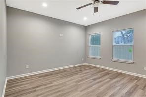 6814 Dumble Street, Unit A Houston, TX 77021 - Photo 8 of 22 an empty room with windows and fan