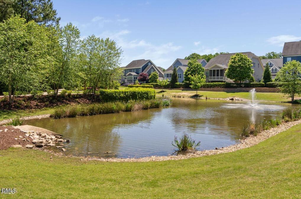 7421 Stonehenge Farm Lane Raleigh, NC 27613 - Photo 37 of 48 a view of a lake with a houses