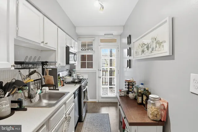 a view of a kitchen with workspace and a window