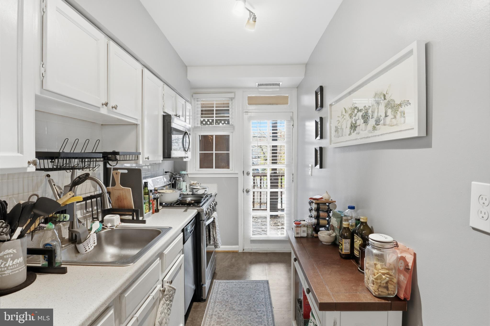 7 Russell Road, Unit D Alexandria, VA 22301 - Photo 11 of 27 a view of a kitchen with workspace and a window