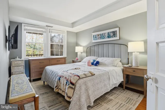 a bedroom with a bed and a large window