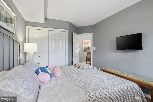 a bedroom with a bed and a flat screen tv