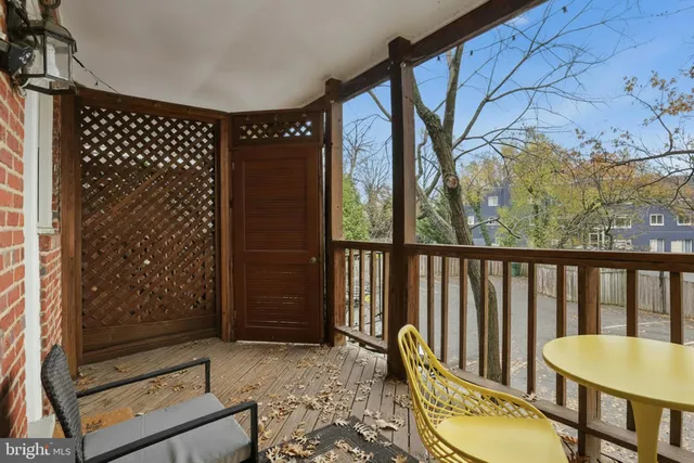 a living room with a large window and wooden floor