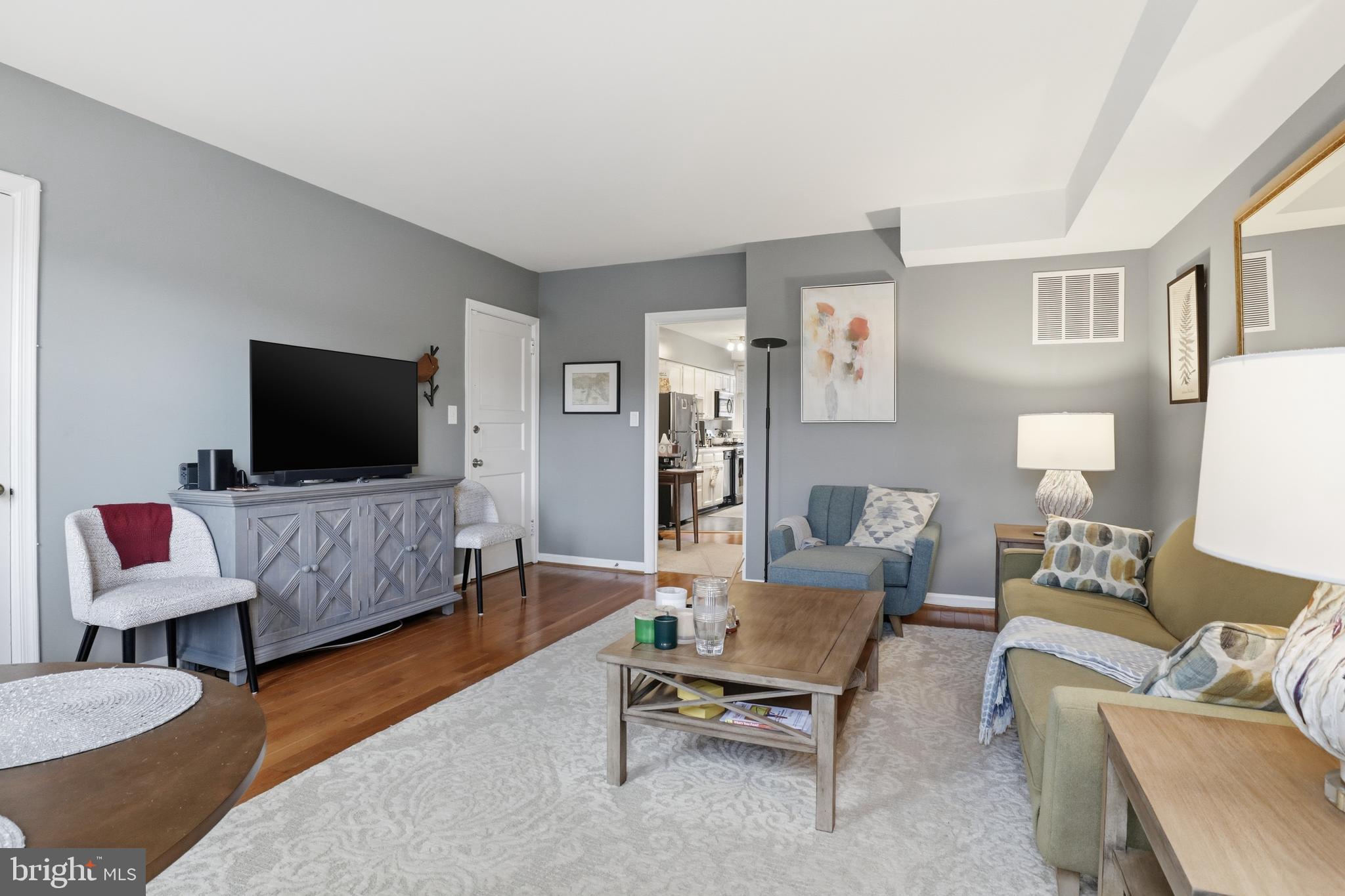 7 Russell Road, Unit D Alexandria, VA 22301 - Photo 6 of 27 a living room with furniture and a flat screen tv