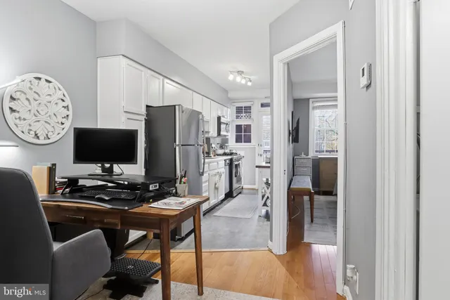 a kitchen with stainless steel appliances a refrigerator and a stove top oven