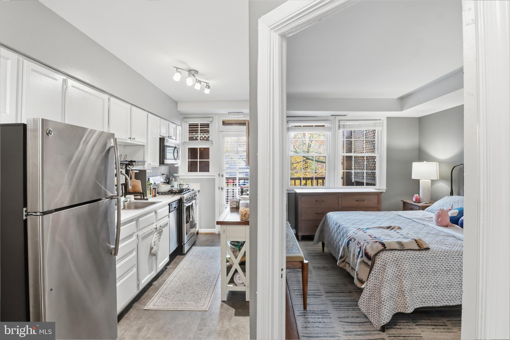 7 Russell Road, Unit D Alexandria, VA 22301 - Photo 9 of 27 a kitchen with a refrigerator a stove top oven a sink and cabinets