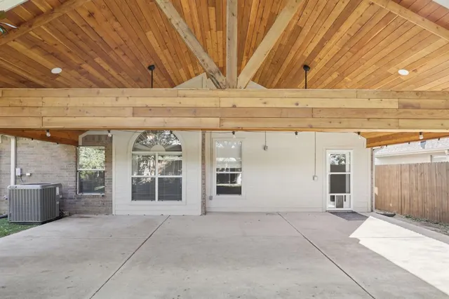 a view of a house with a yard and large tree