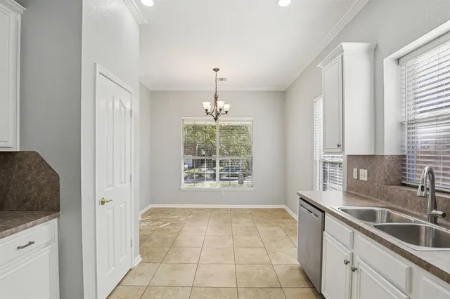 a kitchen with a sink window and cabinets