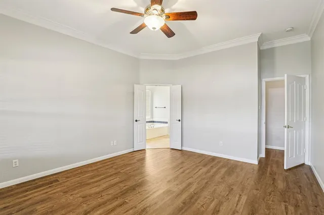 a view of a room with wooden floor and white walls