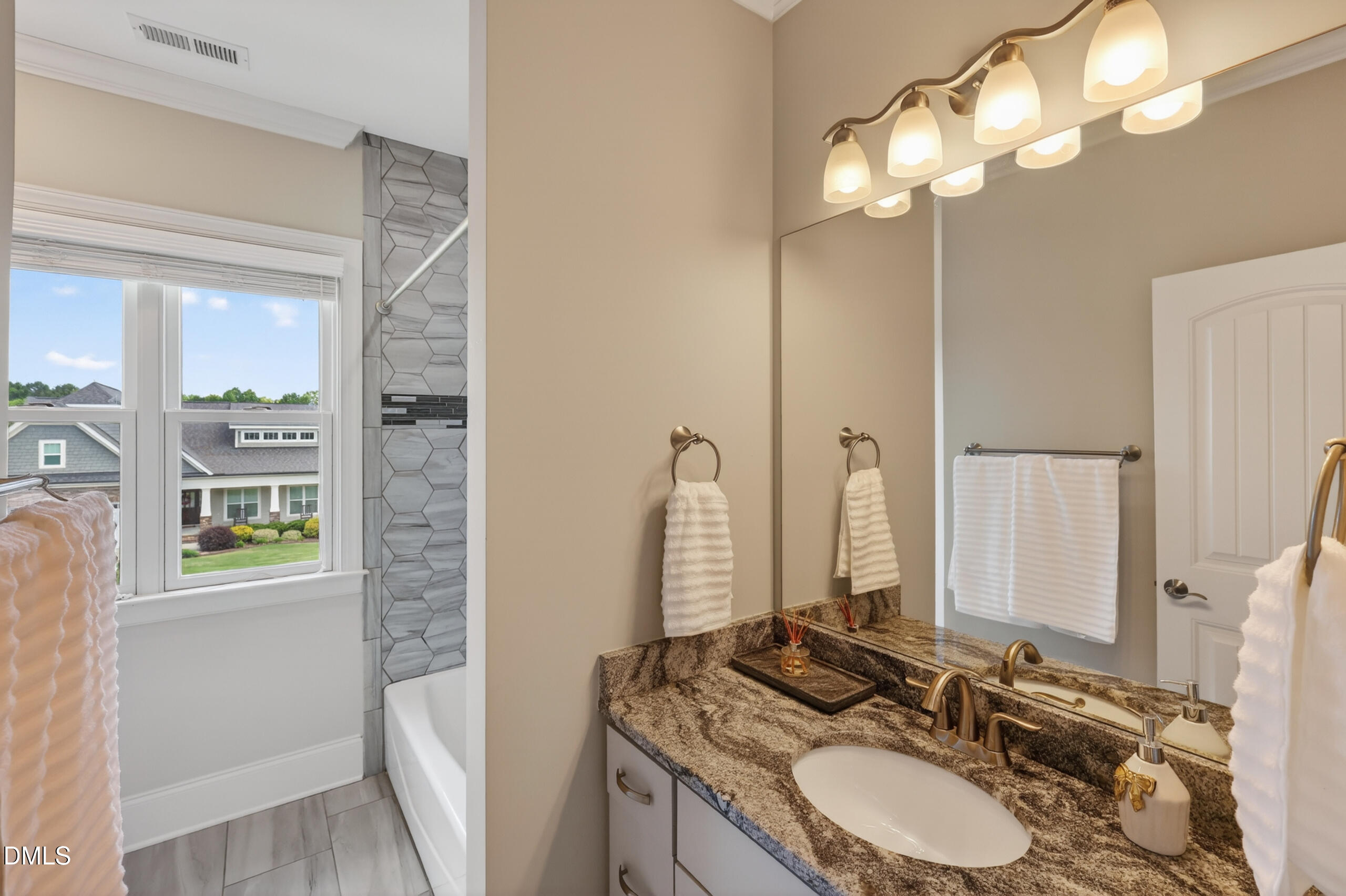 261 Character Drive Rolesville, NC 27571 - Photo 49 of 77 a bathroom with a granite countertop sink and a mirror
