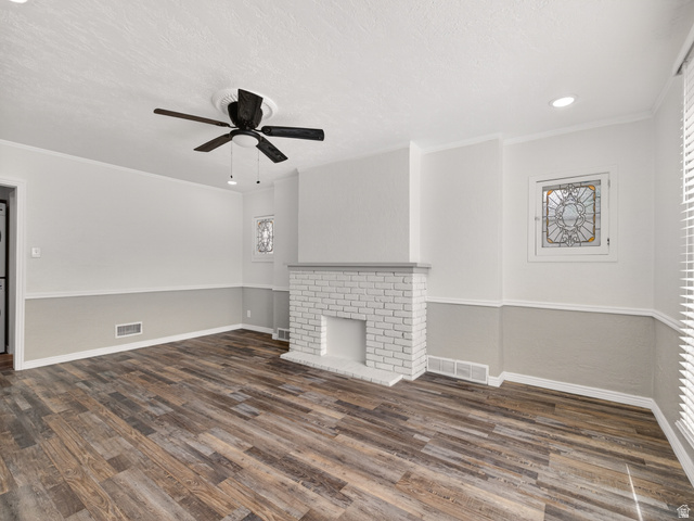 74 South 300 East Springville, UT 84663 - Photo 7 of 48 Living area featuring wood-finish flooring, a painted brick fireplace, a ceiling fan with integrated lighting, recessed lighting, and stained-glass accent windows