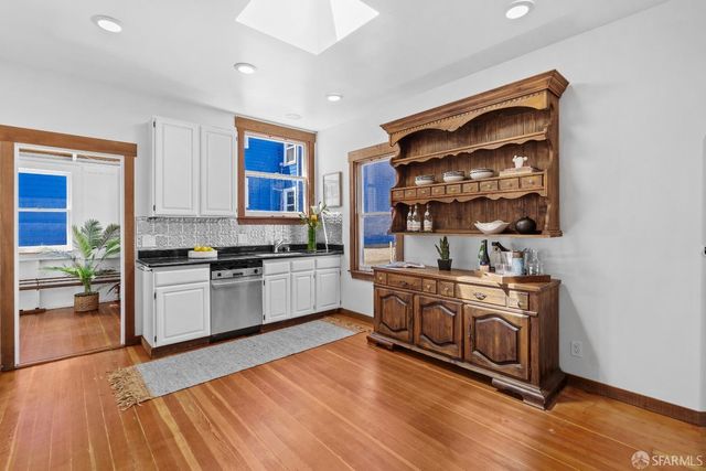 a kitchen with stainless steel appliances granite countertop a stove and a sink
