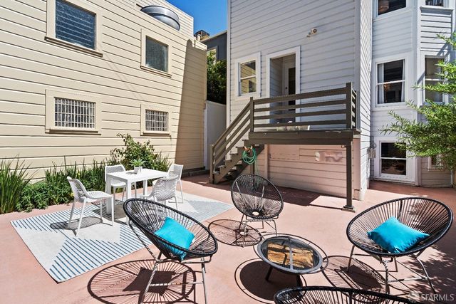 a table and chairs are sitting on the wooden floor