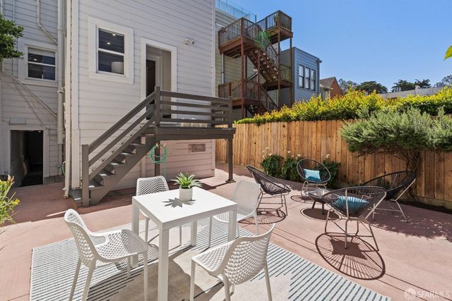 a view of a patio with a table and chairs