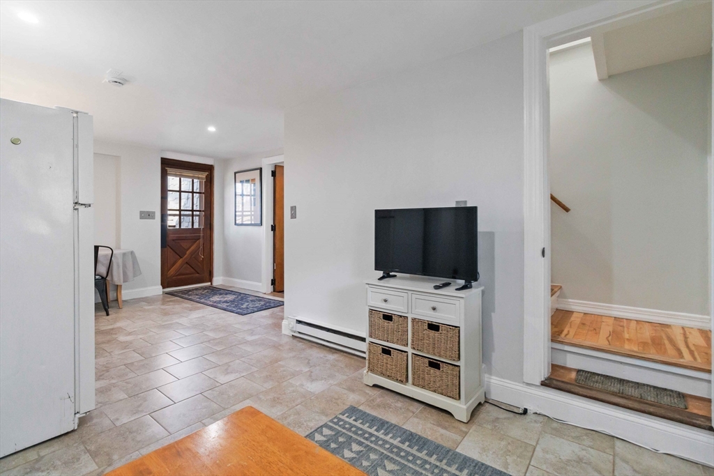 21 A Stowe Road, Unit A Southborough, MA 01772 - Photo 11 of 24 a view of a livingroom with a flat screen tv and windows