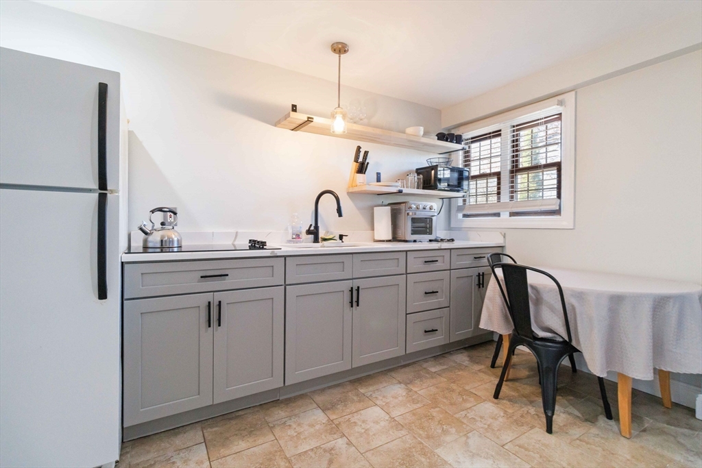 21 A Stowe Road, Unit A Southborough, MA 01772 - Photo 13 of 24 a spacious bathroom with a double vanity sink a mirror a window and a shower