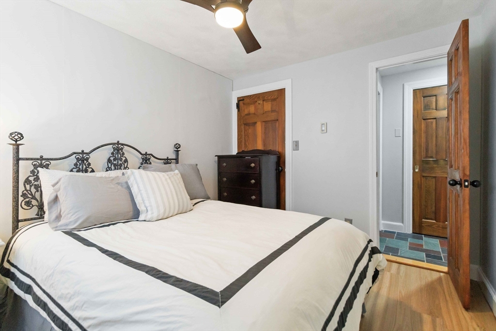 21 A Stowe Road, Unit A Southborough, MA 01772 - Photo 16 of 24 a bedroom with a bed and a mirror