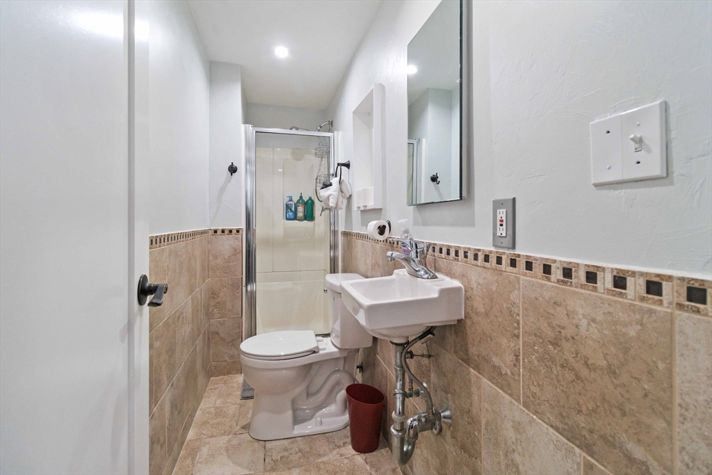 21 A Stowe Road, Unit A Southborough, MA 01772 - Photo 20 of 24 a bathroom with a sink toilet and shower