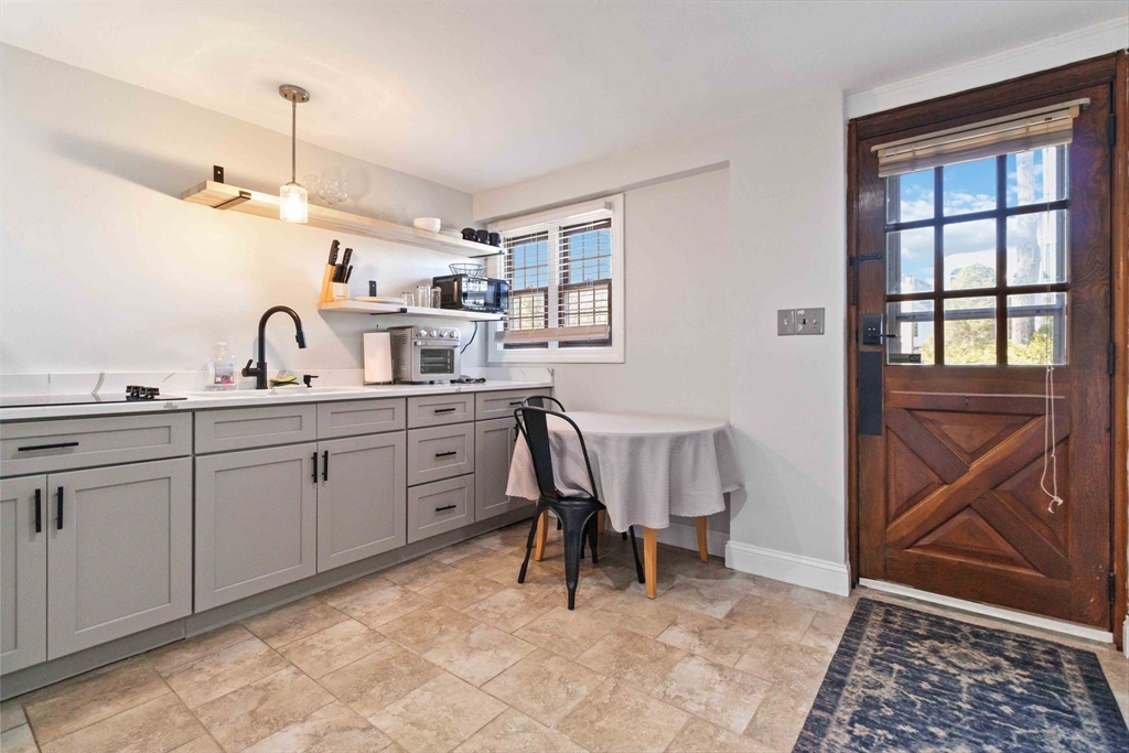 21 A Stowe Road, Unit A Southborough, MA 01772 - Photo 2 of 24 a view of a kitchen area with furniture and windows
