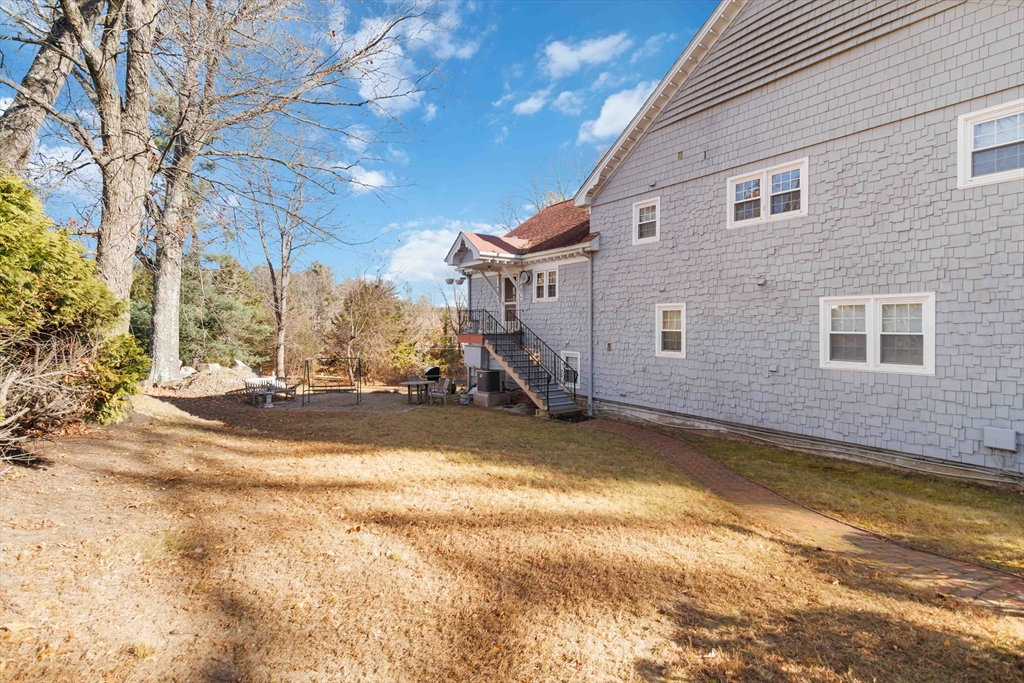 21 A Stowe Road, Unit A Southborough, MA 01772 - Photo 22 of 24 a view of a house with snow on the road