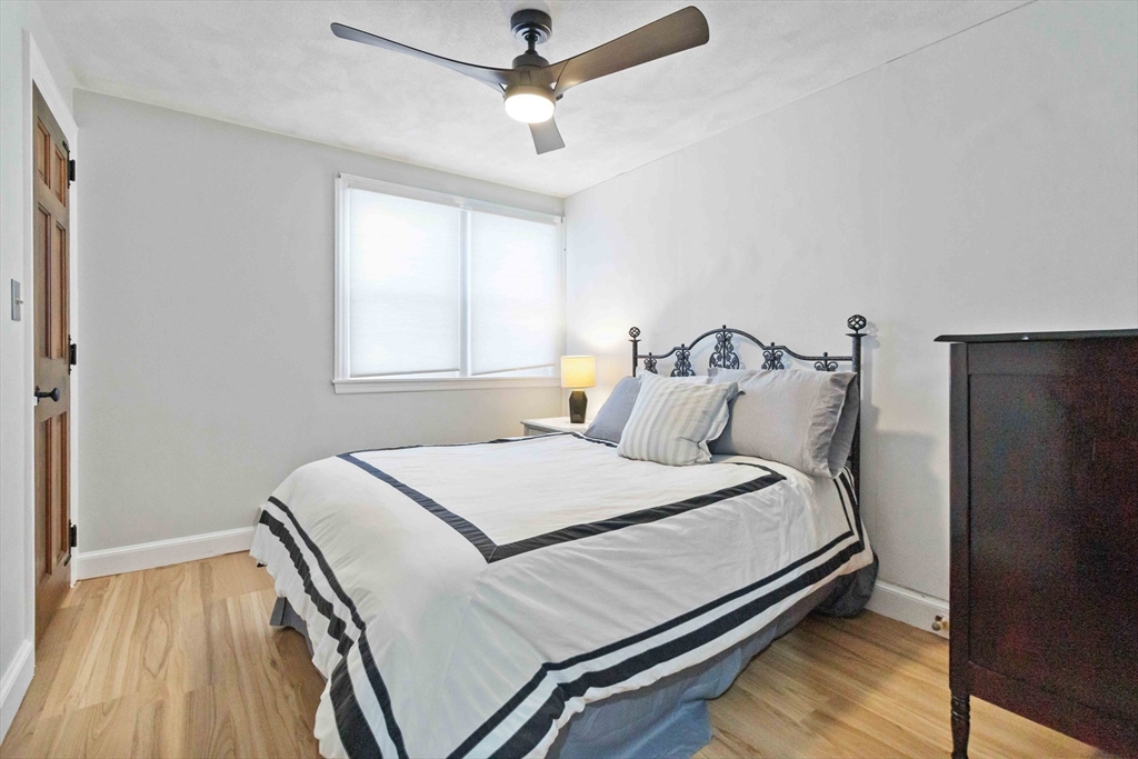 21 A Stowe Road, Unit A Southborough, MA 01772 - Photo 5 of 24 a bedroom with a bed and wooden floor