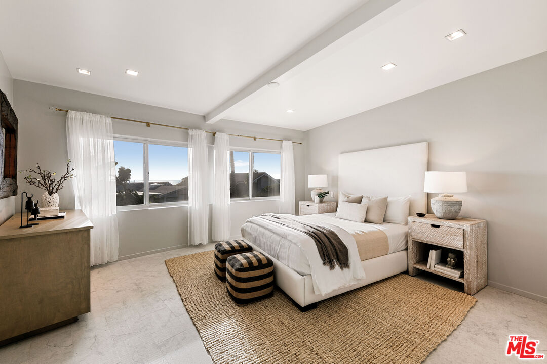 31558 Victoria Point Road Malibu, CA 90265 - Photo 43 of 55 a spacious bedroom with a bed and a view of kitchen