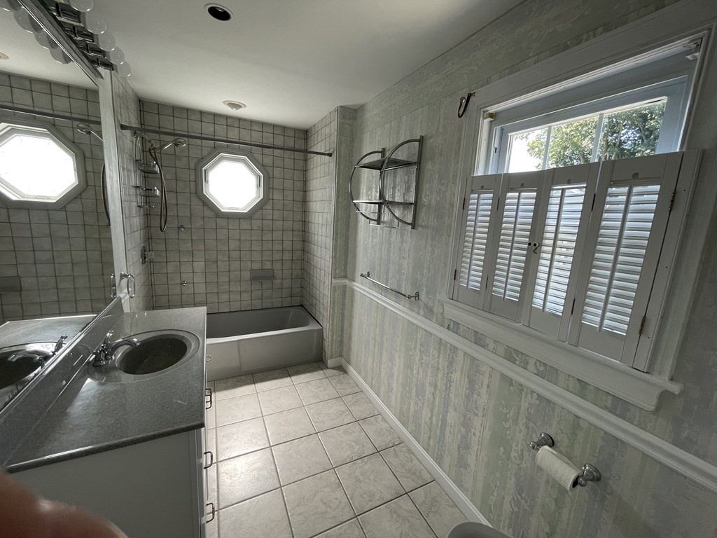 10 Weldon Road Newton, MA 02458 - Photo 11 of 23 a bathroom with a sink a toilet and shower