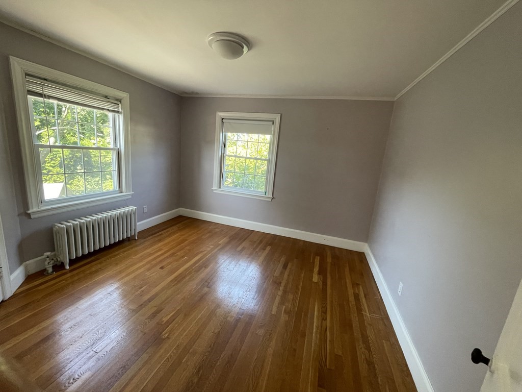 10 Weldon Road Newton, MA 02458 - Photo 12 of 23 a view of an empty room with wooden floor and a window