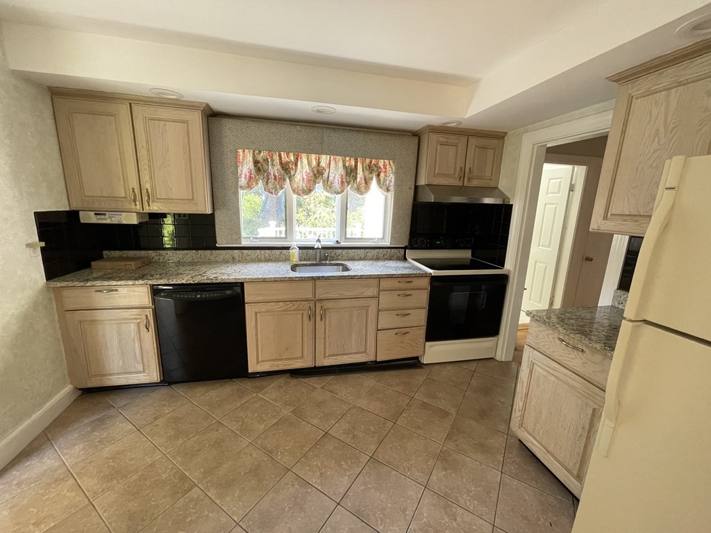 10 Weldon Road Newton, MA 02458 - Photo 13 of 23 a kitchen with stainless steel appliances a stove a sink and a refrigerator