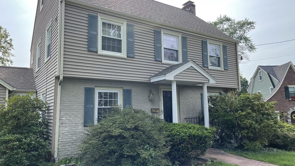 10 Weldon Road Newton, MA 02458 - Photo 2 of 23 a front view of a house with a yard and trees