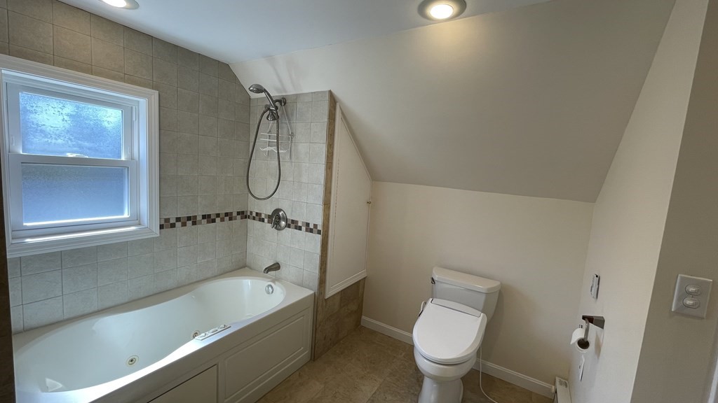 10 Weldon Road Newton, MA 02458 - Photo 21 of 23 a bathroom with a granite countertop toilet a sink and a bathtub