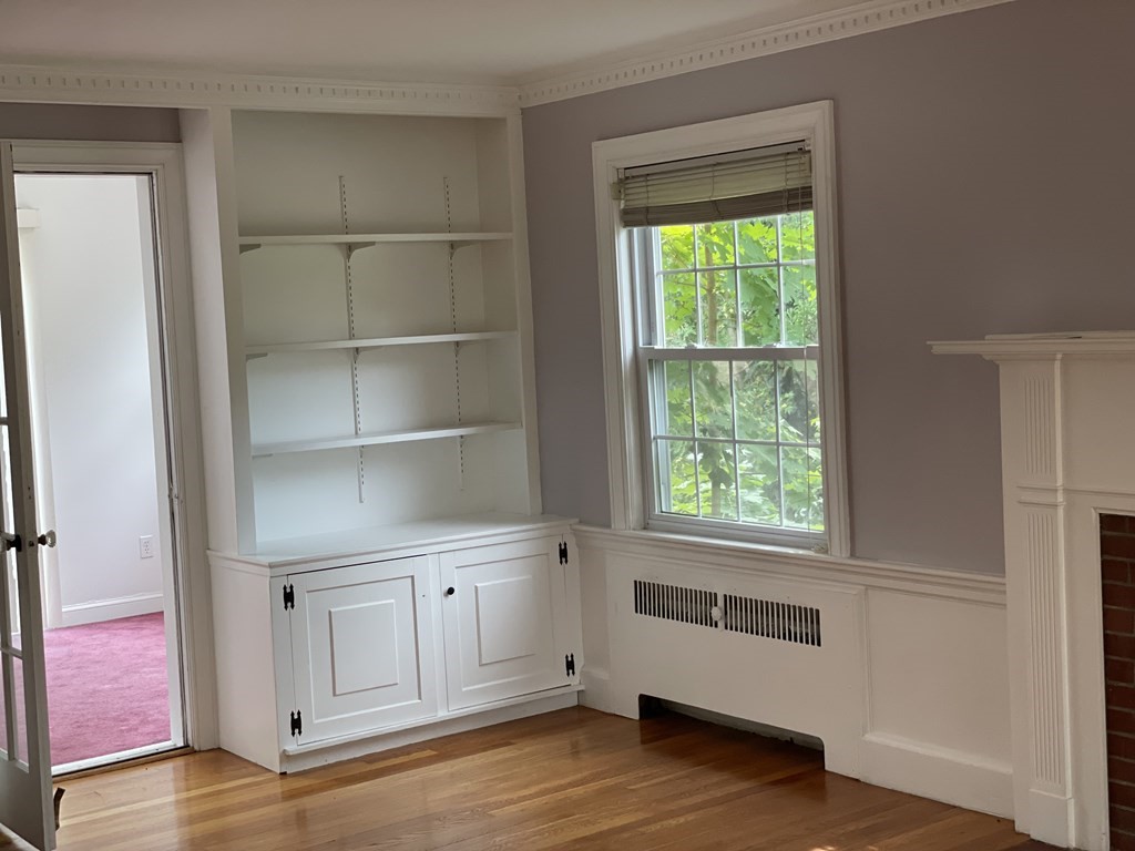10 Weldon Road Newton, MA 02458 - Photo 4 of 23 a view of an empty room with a window and wooden floor