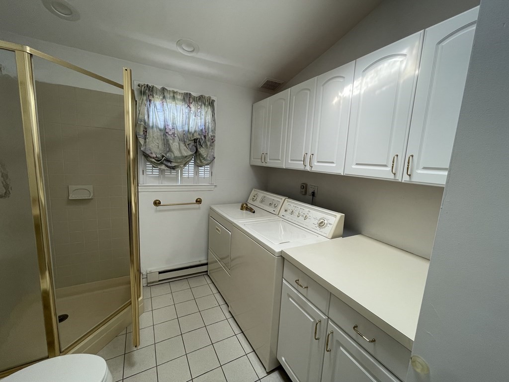 10 Weldon Road Newton, MA 02458 - Photo 7 of 23 a utility room with cabinets washer and dryer