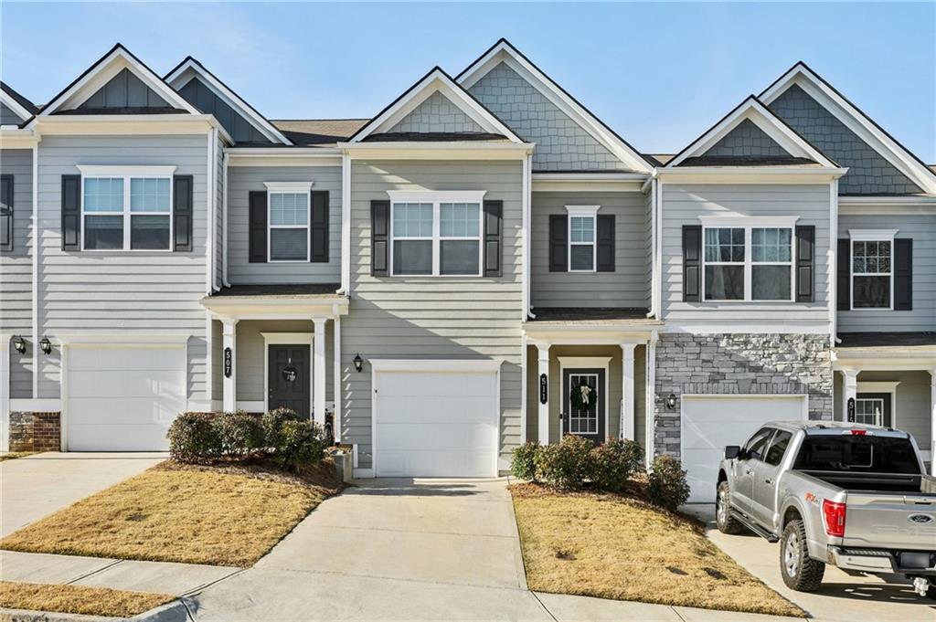 a view of a house with cars parked in front of house